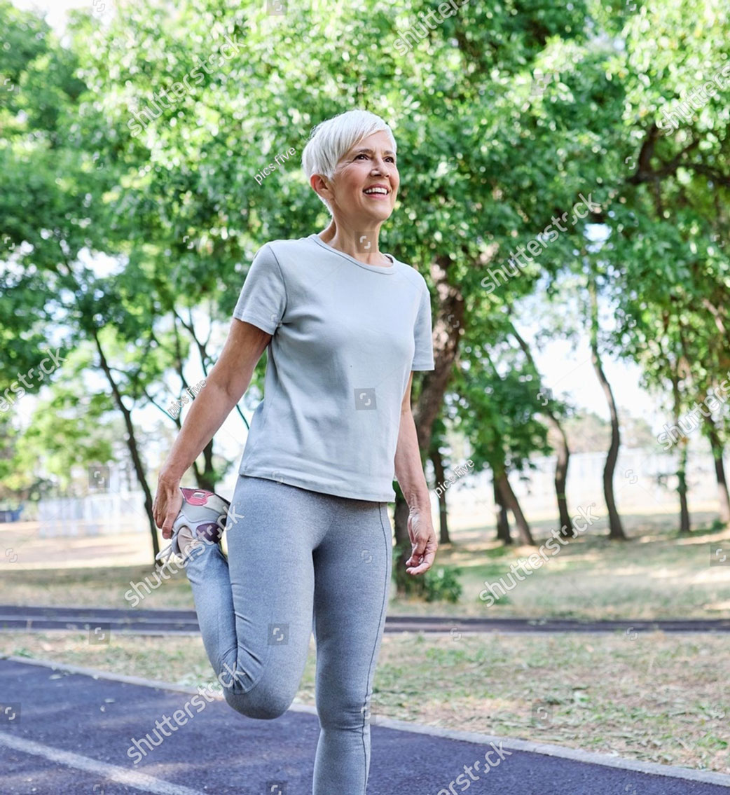 a senior mature woman exercising stretching warming up running and jogging outdoors